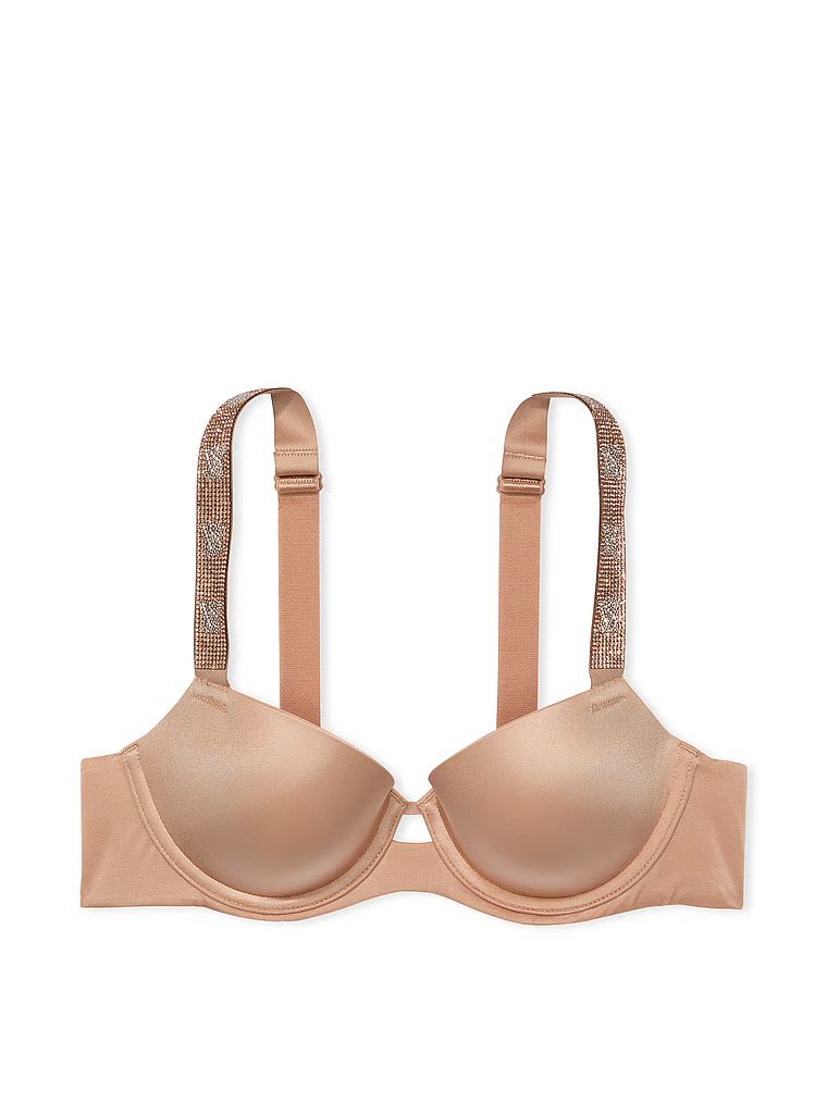 Na zdjęciu na białym tle widoczny jest biustonosz lekko usztywniany z błyszczącymi ramiączkami Shine Strap Demi. Produkt ma kolor beżowy i pochodzi z kolekcji Very Sexy.
