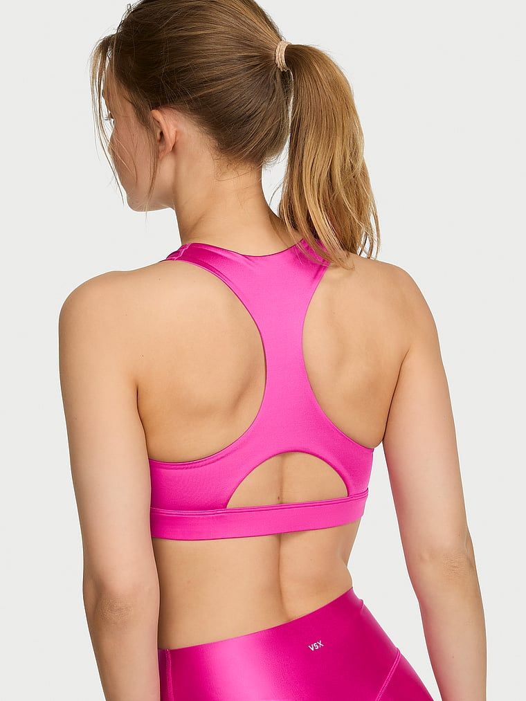 Biustonosz sportowy z błyszczącego materiału VSX GlossyTech. Produkt ma kolor różowy i pochodzi z kolekcji VSX. 