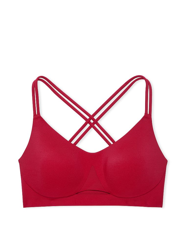Na zdjęciu na białym tle widoczny jest biustonosz sportowy z lekkim wsparciem Elevate Strappy. Produkt ma kolor czerwony i pochodzi z kolekcji VSX.