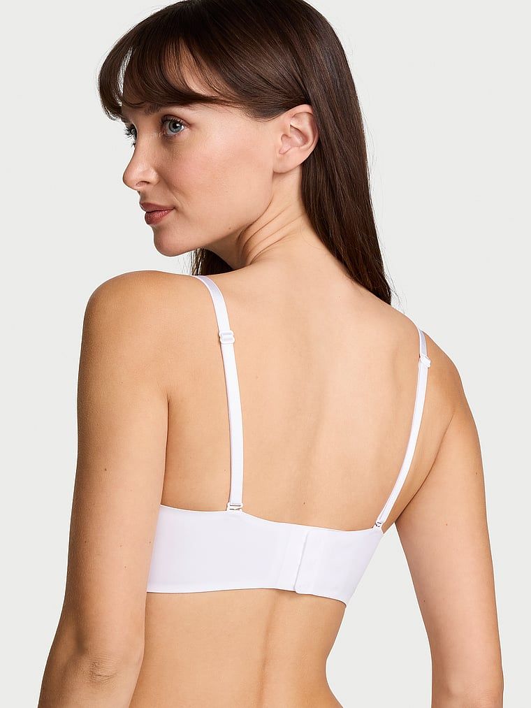 Biustonosz push-up bez ramiączek powiększający o 2 rozmiary Bombshell. Produkt ma kolor biały i pochodzi z kolekcji Invisible by Victoria's Secret. 