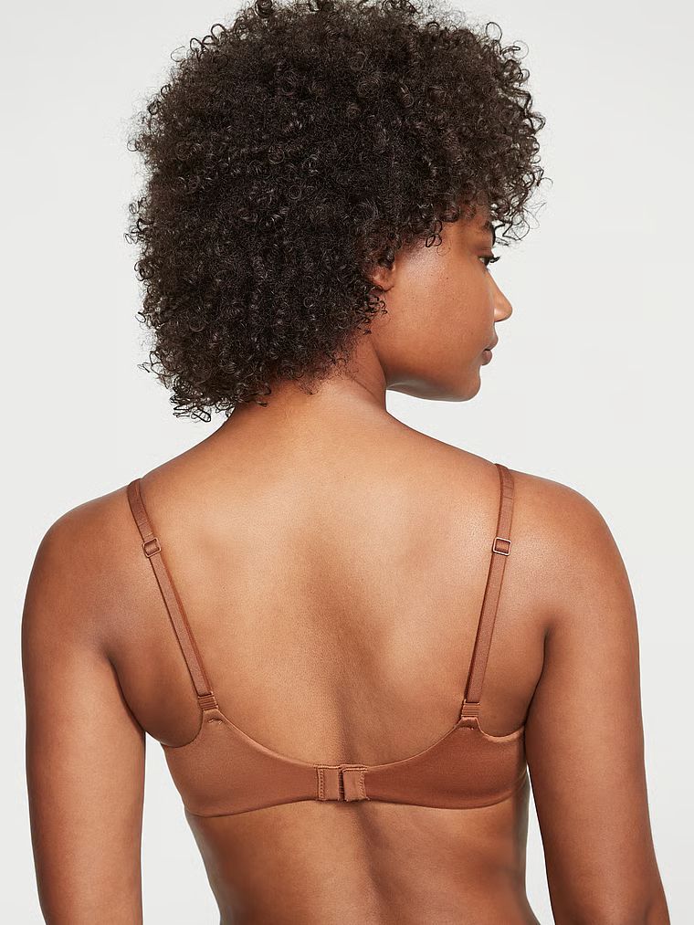 Modelka prezentuje biustonosz lekko usztywniany z mocno zabudowanymi miseczkami Infinity Edge. Produkt ma kolor brązowy i pochodzi z kolekcji Body by Victoria.