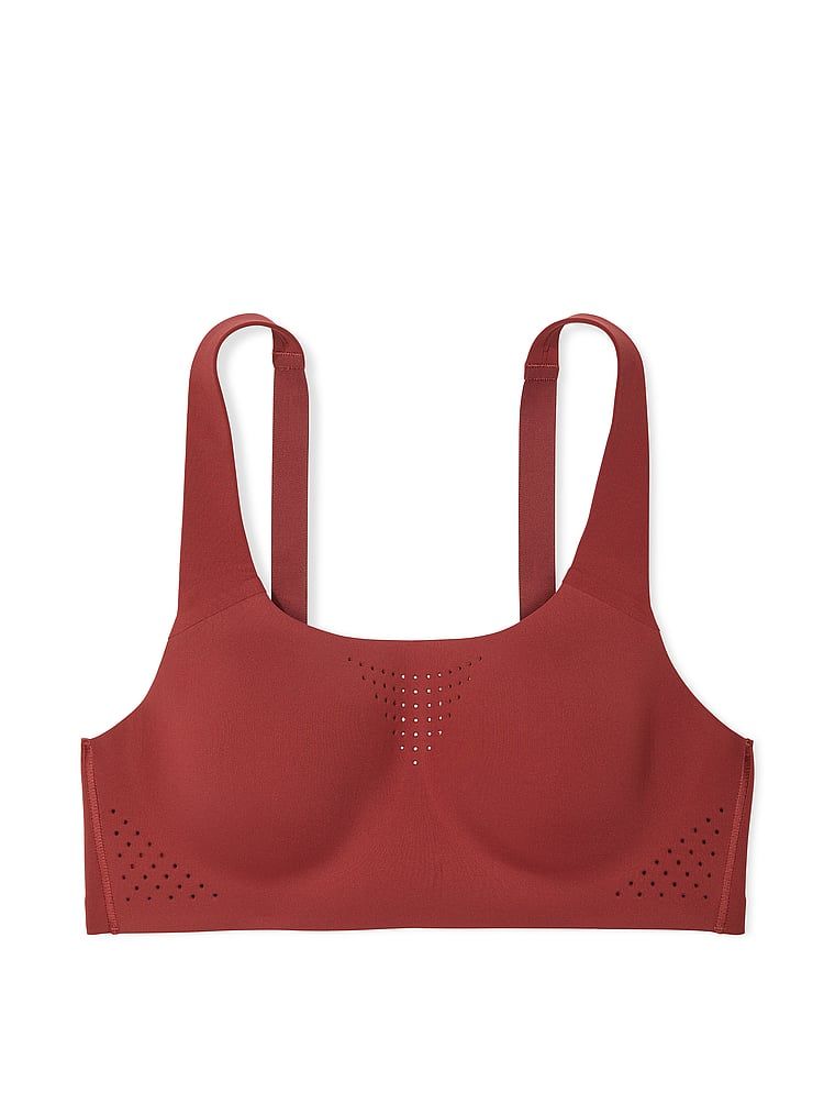 Na zdjęciu na białym tle widoczny jest biustonosz sportowy z maksymalnym podtrzymaniem Featherweight Max. Produkt ma kolor czerwony i pochodzi z kolekcji VSX.