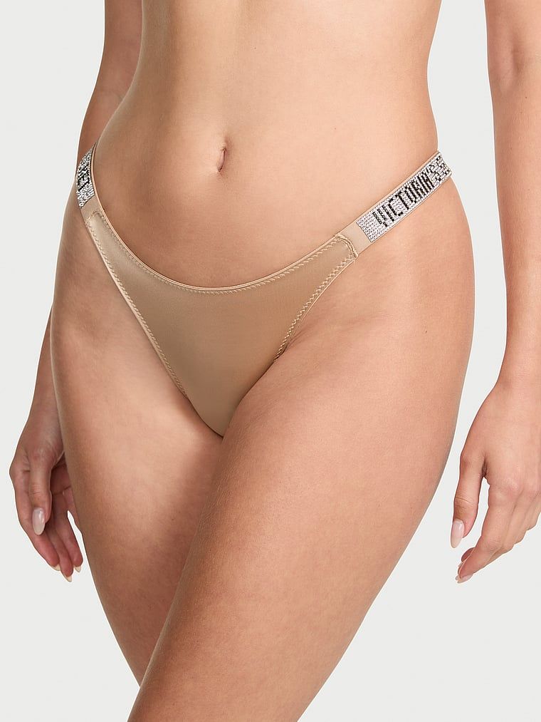 Majtki brazyliany z błyszczącymi paskami Shine Strap Brazilian. Produkt ma kolor beżowy i pochodzi z kolekcji Very Sexy. 