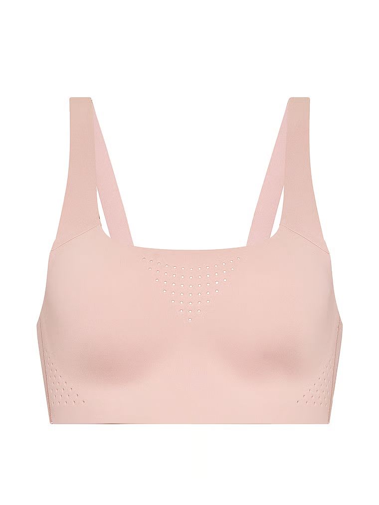 Na zdjęciu na białym tle widoczny jest biustonosz sportowy z maksymalnym podtrzymaniem Featherweight Max. Produkt ma kolor beżowy i pochodzi z kolekcji VSX.