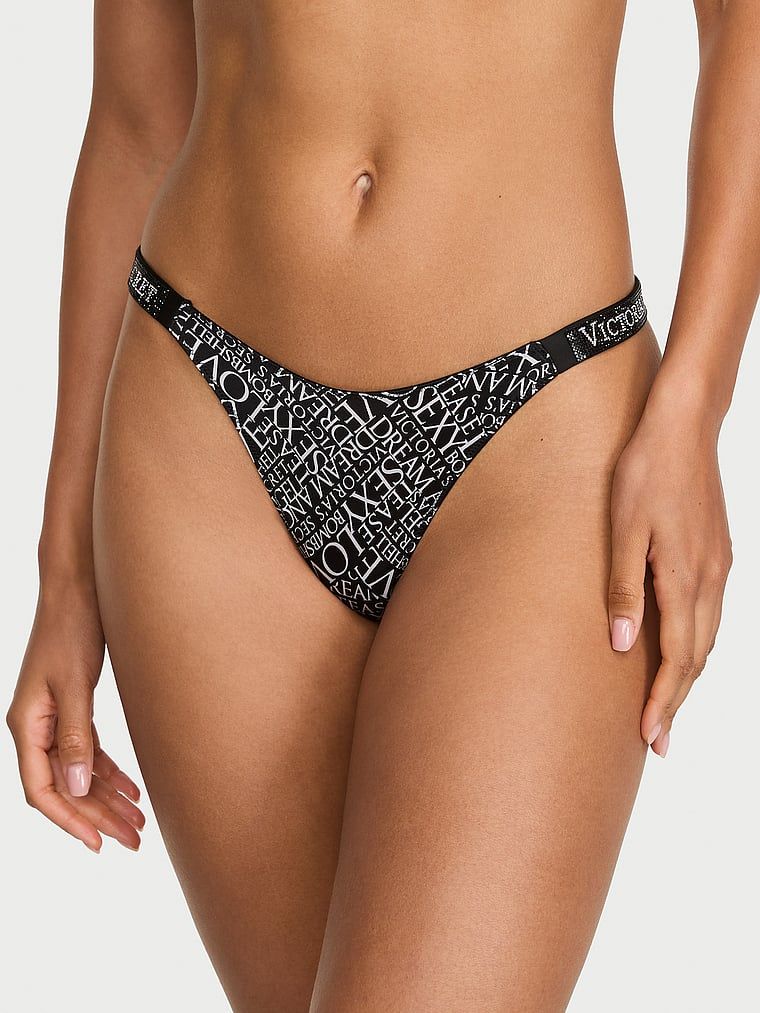 Stringi z błyszczącymi paskami Shine Strap. Produkt ma kolor wzorzysty i pochodzi z kolekcji Very Sexy. 