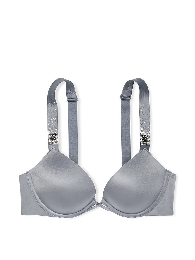 Na zdjęciu na białym tle widoczny jest biustonosz push-up powiększający o 2 rozmiary Bombshell Scattered Shine Strap. Produkt ma kolor szary i pochodzi z kolekcji Very Sexy.