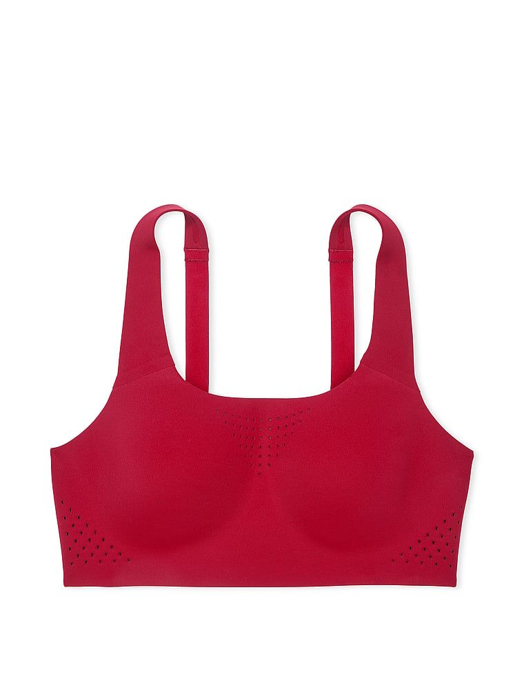 Na zdjęciu na białym tle widoczny jest biustonosz sportowy z maksymalnym podtrzymaniem Featherweight Max. Produkt ma kolor czerwony i pochodzi z kolekcji VSX.