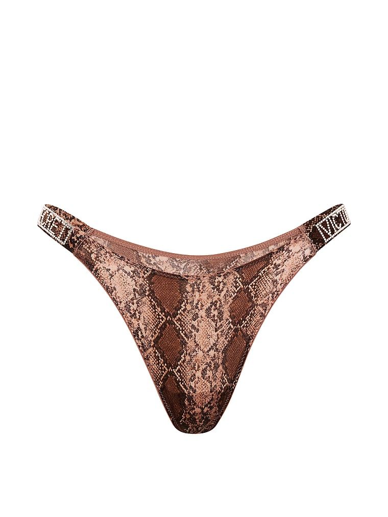 Majtki brazyliany koronkowe z błyszczącymi paskami Shine Strap Brazilian. Produkt ma kolor wzorzysty i pochodzi z kolekcji Very Sexy. 