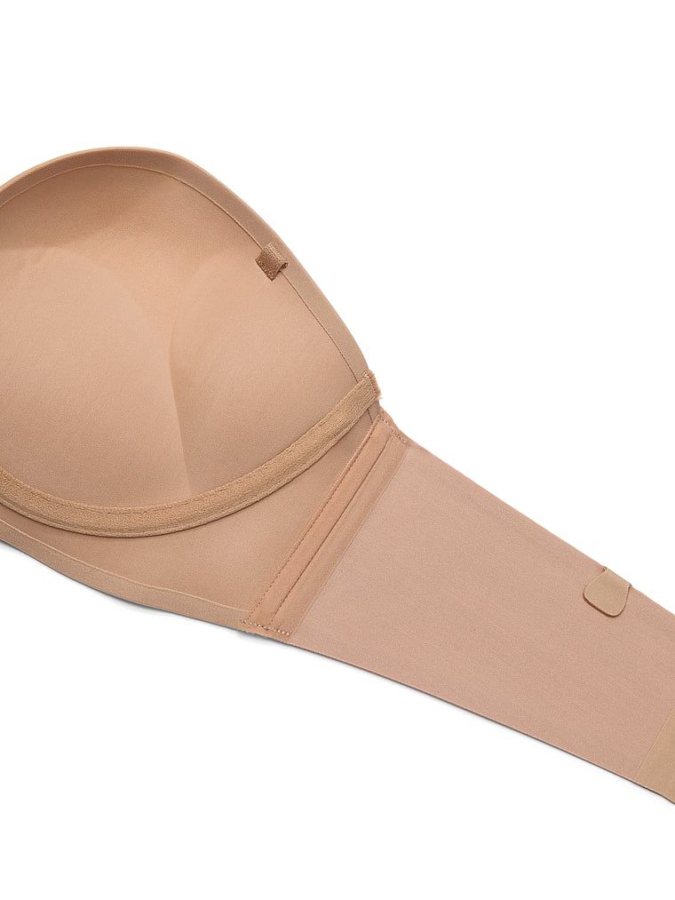 Biustonosz push-up bez ramiączek powiększający o 2 rozmiary Bombshell. Produkt ma kolor beżowy i pochodzi z kolekcji Invisible by Victoria's Secret. 