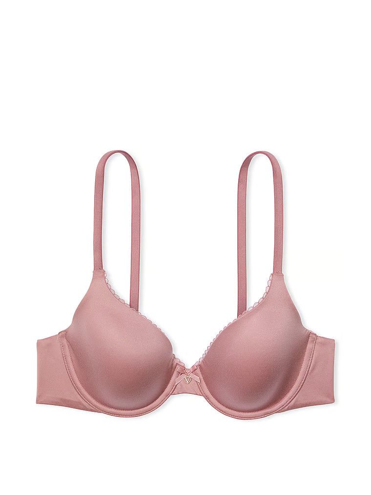 Na zdjęciu na białym tle widoczny jest biustonosz lekko usztywniany z mocno zabudowanymi miseczkami. Produkt ma kolor różowy i pochodzi z kolekcji Body by Victoria.