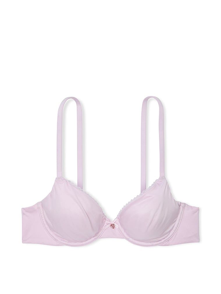 Na zdjęciu na białym tle widoczny jest biustonosz nieusztywniany Invisible Lift Smooth Demi. Produkt ma kolor purpurowy i pochodzi z kolekcji Body by Victoria.