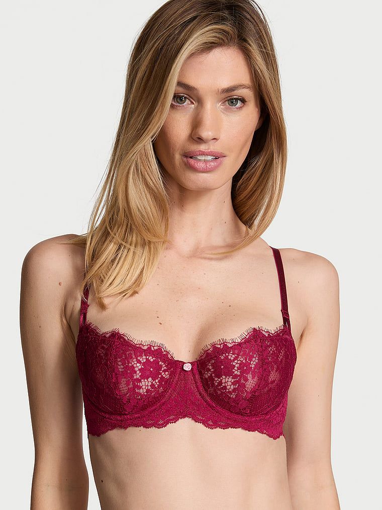Modelka prezentuje biustonosz nieusztywniany balkonetka Wicked Lace Balconette. Produkt ma kolor czerwony i pochodzi z kolekcji Dream Angels.