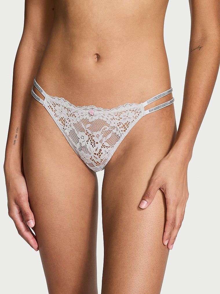 Majtki brazyliany koronkowe z błyszczącymi paseczkami Twinkle Strap Brazilian. Produkt ma kolor szary i pochodzi z kolekcji Dream Angels. 