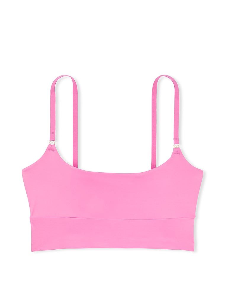 Na zdjęciu na białym tle widoczny jest biustonosz braletka Feathersoft Essentials. Produkt ma kolor różowy i pochodzi z kolekcji Victoria's Secret.