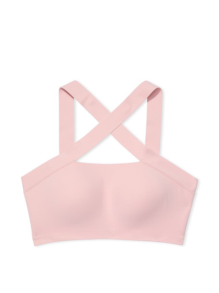Na zdjęciu na białym tle widoczny jest biustonosz sportowy VS Elevate Cross-Strap Bandeau. Produkt ma kolor różowy i pochodzi z kolekcji VSX.