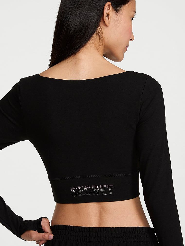 Crop top z długimi rękawami bawełniany. Produkt ma kolor czarny i pochodzi z kolekcji Angel Essentials. 
