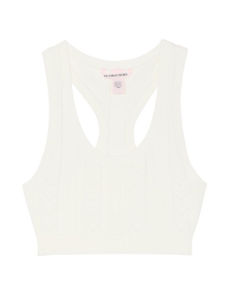 Na zdjęciu na białym tle widoczny jest biustonosz braletka z dziurkowanego materiału Luxe Heart Pointelle. Produkt ma kolor biały i pochodzi z kolekcji Victoria's Secret.